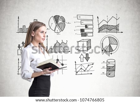 Side view of a blonde businesswoman wearing a white blouse, a black skirt and holding a copybook. A concrete wall background with an infographic on it