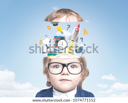 Portrait of a cute little baby boy wearing glasses and a suit and looking to the camera. A sky with clouds background with a colorful start up sketch