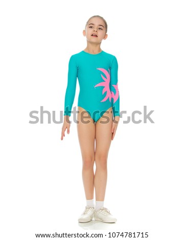 Very flexible little girl gymnast, junior school age, in a beautiful gymnastic swimsuit turquoise.She is posing in front of the camera.Isolated on white background.