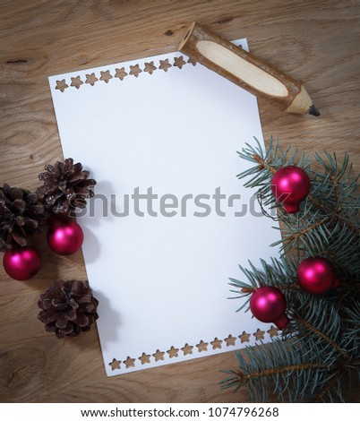 blank Christmas card and ornaments on wooden background.
