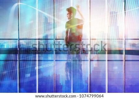 Young businessman standing in modern office with creative forex chart. City background. Investment and stock concept. Double exposure 