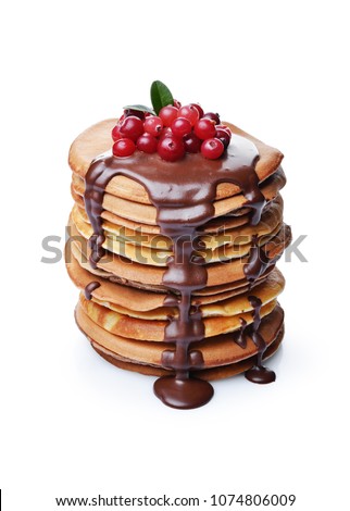 Tasty breakfast. Homemade pancakes with fresh cranberry and melted chocolate isolated on white background