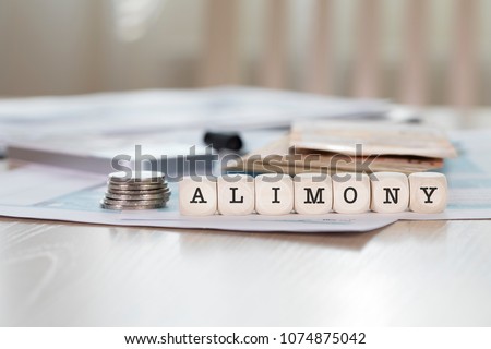 Word ALIMONY composed of wooden letters. Closeup Royalty-Free Stock Photo #1074875042
