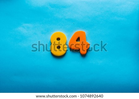 84 years old celebrating classic logo. Colored happy  eighty-four  yellow orange numbers. Greetings celebrates card. Traditional  digits of ages.  Sale, birthday, special prize, % off concept.