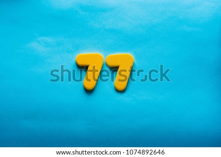 77 years old celebrating classic logo. Colored happy numbers. Greetings celebrates card. Traditional digits of ages.  Sale, birthday, special prize, % off concept.