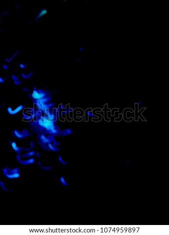 A free spirit captured. Visualization of a soul separated from a body, interacting with other yellow loose souls. This is what souls look like.  Blue Light Motion Blur. EDM party.