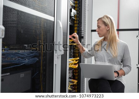 IT expert checking supercomputer server