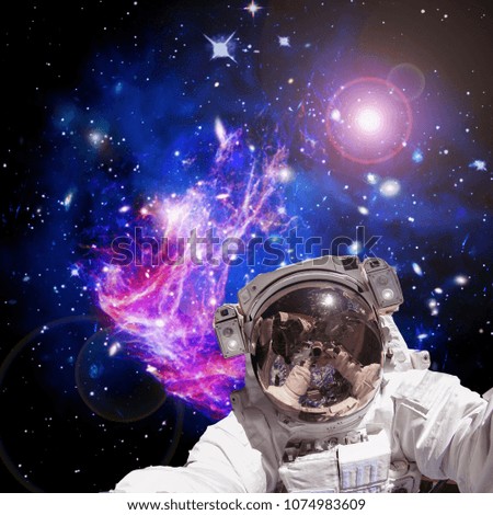 Astronaut and stars and galaxies on the backdrop. The elements of this image furnished by NASA.
