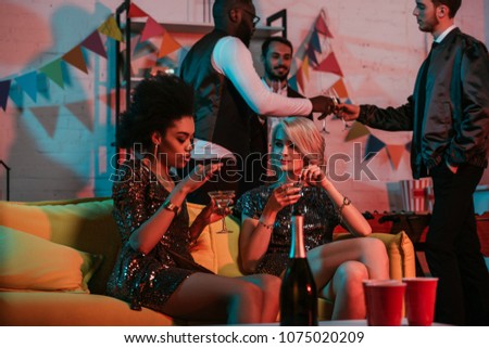 Multiracial friends having party with champagne drinks