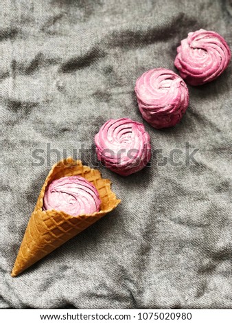waffle cone with pink zephyrs on grey textile background