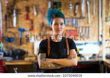 Young woman working in a bicycle repair shop