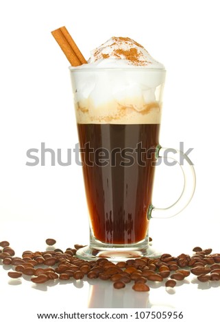 glass of coffee cocktail with coffee beans and cinnamon on white background close-up