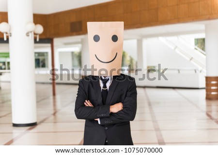 businessman wear paper bag covering head happy emotions 