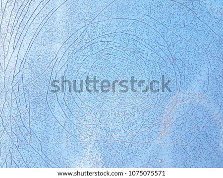 Close-up the Grunge light blue wall with cracked and circle lines in the middle background texture, front view, free space for texts. Concept Crack and Wall.