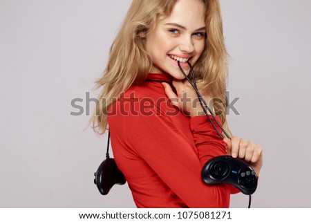  smiling woman holding a joystick                              
