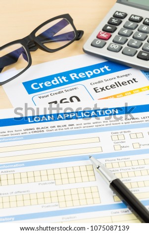 Loan application form excellent credit score with calculator, glasses, and pen
