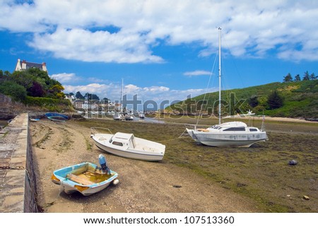 Picture of boats, standing at low tide on the coast of the island Belle Ile en Mer. France.