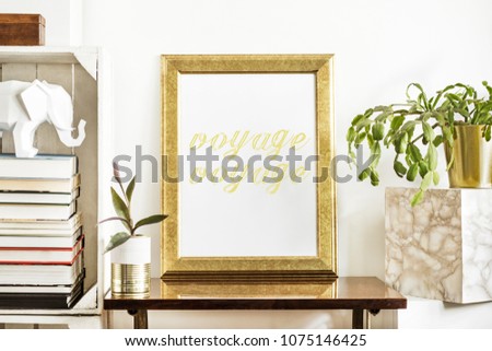 The room interior with gold mock up poster frame, plants, white elephant figure, books  and wooden boxes. Concept of retro shelfie. 