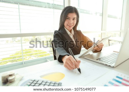 businesswoman working with graph company summary report and using computer and tablet 