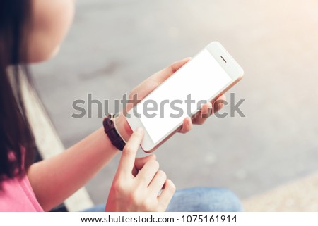 Photo of a woman holding a blank screen phone. film effect. Concept technology and modernization.