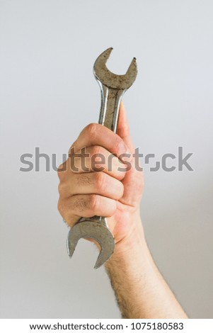hand holding a Wrench
