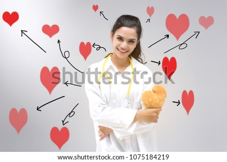 Woman doctor in white dress hold yellow stethoscope and brown heart doll. Stand and red cartoon heart around. tell everybody take care your heart and take care health.