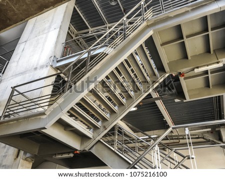 metal stairs with rail and cement building.