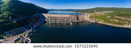 Summer landscape a dam of hydroelectric power station in Siberia on the Yenisei River, shooting from air Royalty-Free Stock Photo #1075223690
