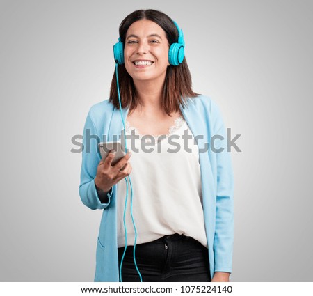 Middle aged woman happy and fun, listening to music, modern headphones, happy feeling the sound and rhythm