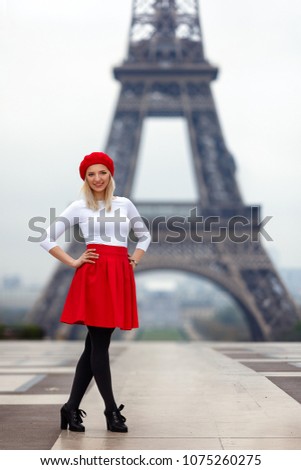 Young woman in Paris in red skirt and red hat Eiffel Tower background outdoors France