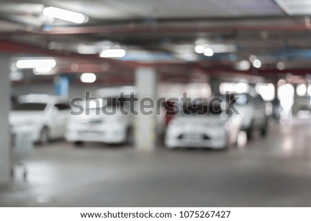 Abstract blurred car parking in shopping mall of department store interior for background.