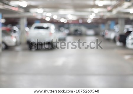 Abstract blurred car parking in shopping mall of department store interior for background.