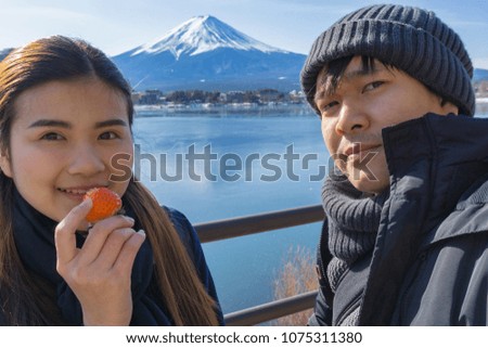 Asian couple and valentines day travel concept.Couple travelers Man and Woman travel the beautiful nature of Mt. Fuji in Japan. Travel and Attractions Concept.