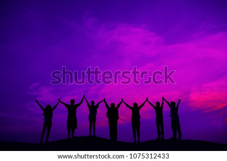 Concept of cooperate to success,Business team hold hands together achievement success mission complete,Silhouette image,copy space