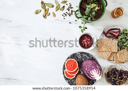 Top view of different organic food on the white marble table background. Enjoy healthy diet. Copy space for slogan. 