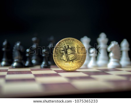 Bitcoin, Golden coin with black and white chess isolated on black background.