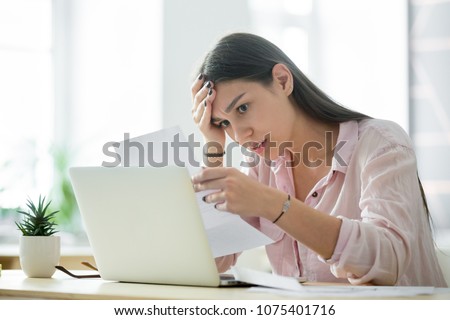 Worried frustrated woman shocked by bad news or rejection reading letter, stressed girl troubled with financial problem, domestic bills or debt, millennial student upset by failed test notification Royalty-Free Stock Photo #1075401716