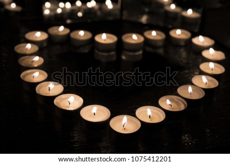 Burring candles in hearth form. Abstract love photo.