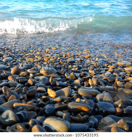Square photo 1: 1. The pebble beach of the black sea and the wave are depicted