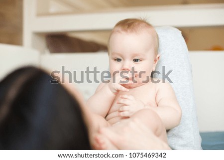 happy loving family. mother playing with her baby in the bedroom