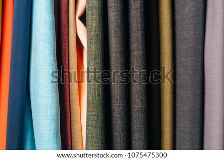 Different types of fabrics are stacked in a row