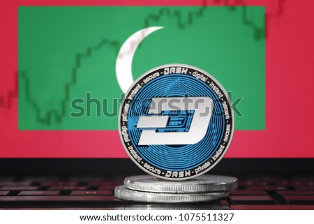 DASH (DigitalCash) cryptocurrency; concept physical dash coin on the background of the flag of Maldives