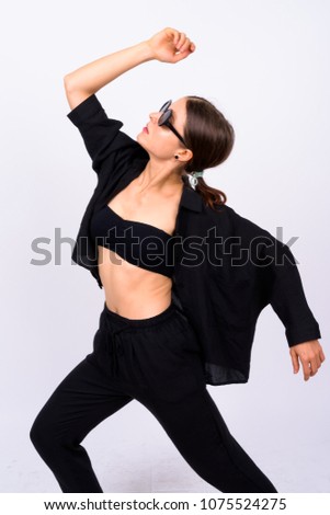 Studio shot of young beautiful woman as secret agent against white background