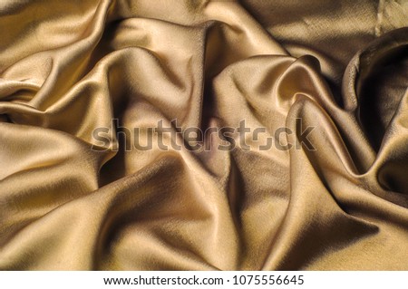 Fabric made of silk fabric metal thread metallic sheen gold. Just like looking at a stunning waterfall, this golden yellow Silk Charmeuse stands alone. Luminous and light-flowing steel metallic color