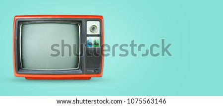 Retro television - old vintage tv on color background. retro technology. flat lay, top view hero header. vintage color styles.  Royalty-Free Stock Photo #1075563146