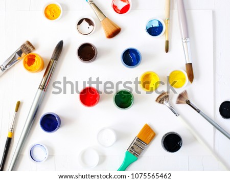Paints and brushes. Art and craft background, top view.