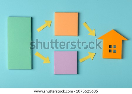 Color paper blocks, arrows and house model. Real estate infographics template on blue background.
