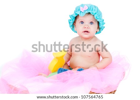 Adorable baby, caucasian, blonde and with stunning blue eyes. The girl is isolated on white. The kid is playing with bath toys.