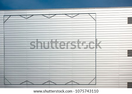 Blank billboard steel frame on facade of industial style building