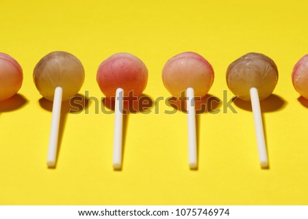 Ball lollipops on a yellow background.